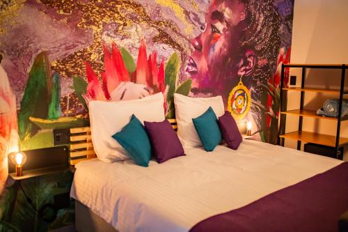 a bedroom with a bed with a painting on the wall at Casa iLanga guesthouse in Somerset West