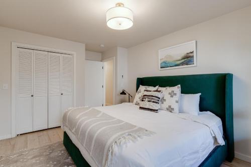 a bedroom with a large bed with a green headboard at Teewinot C2 in Teton Village