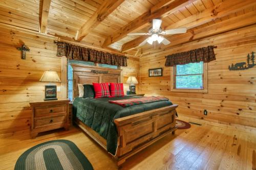 a bedroom with a bed in a log cabin at Forest Hideaway in Maggie Valley