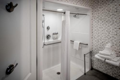 a bathroom with a shower with a shower curtain at Holiday Inn Hotel & Suites Beckley by IHG in Beckley