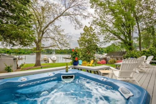 a jacuzzi tub in a backyard with a table and chairs at Base Camp on the Lake in Annapolis