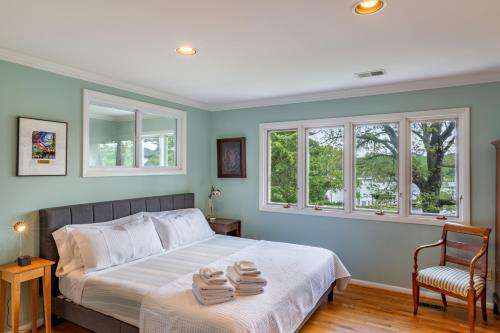 a bedroom with a bed with two towels on it at Base Camp on the Lake in Annapolis