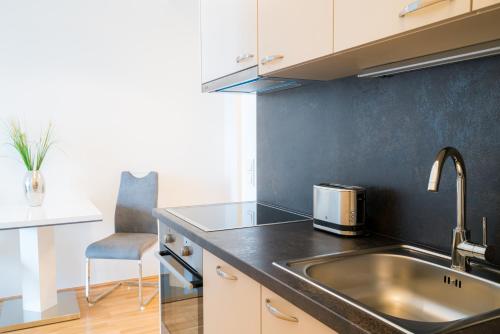 a kitchen with a sink and a counter top at Vienna Residence, Marina Tower - Danube in Vienna