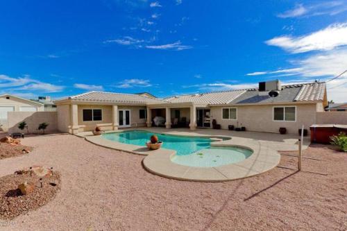a house with a swimming pool in a yard at PRIVATE VIEW ON THE LAKE SIDE OF 95! Sleeps 16 in Lake Havasu City
