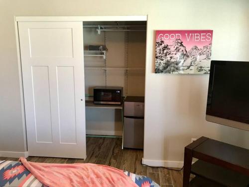 a room with a door leading to a kitchen with a microwave at PRIVATE VIEW ON THE LAKE SIDE OF 95! Sleeps 16 in Lake Havasu City