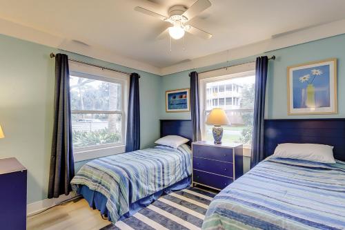 a bedroom with two beds and a window at SeaEscape in Folly Beach