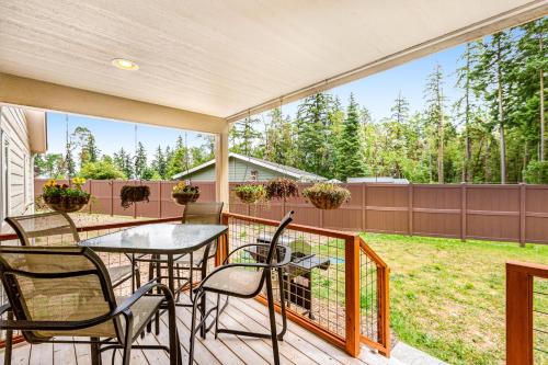 a patio with a table and chairs on a deck at Port Townsend Kala Point in Port Townsend