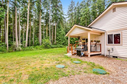 a backyard with a house with a grill and trees at Port Townsend Kala Point in Port Townsend