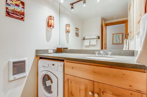 a bathroom with a sink and a washing machine at Tensleep B9 in Teton Village