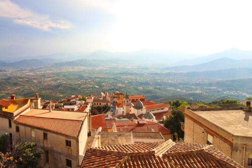 a view of a city with buildings and mountains at Appartamenti Nicolò in Baunei