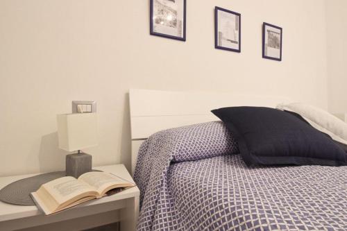 a bedroom with a bed with a book on a desk at Appartamenti Nicolò in Baunei