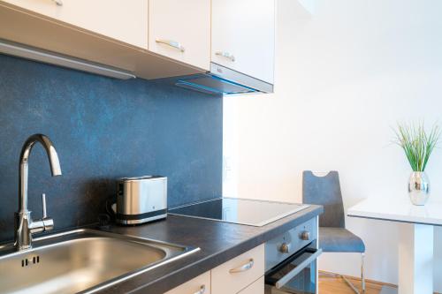a kitchen with a sink and a counter top at Vienna Residence, Marina Tower - Danube in Vienna