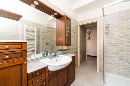 a bathroom with a sink and a shower at Monti Guesthouse in Mestre