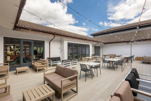 a patio with tables and chairs on a deck at Holiday Inn Guildford by IHG in Guildford