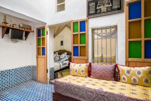 a living room with a couch and a bedroom at Dar Fatimazahra in Fès