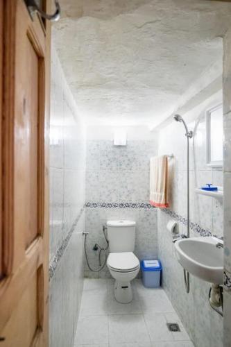 a small bathroom with a toilet and a sink at Dar Fatimazahra in Fès