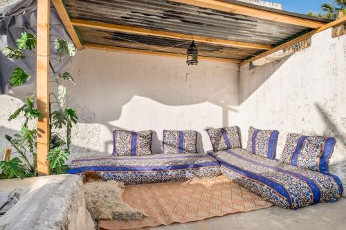 a dog laying on the ground under a pergola at Dar Fatimazahra in Fès