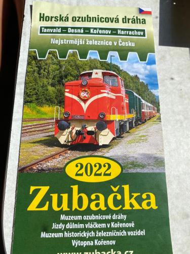 a magazine with a red train on the tracks at Slunný byt v Jizerských horách 5 postelí in Tanvald
