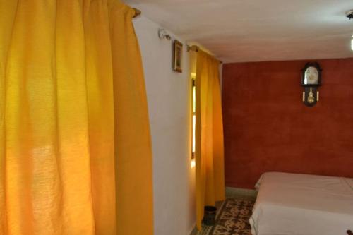 a bedroom with two beds and an orange curtain at Dar Fatimazahra in Fès