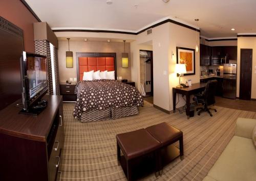 a hotel room with a bed and a desk at Staybridge Suites DFW Airport North, an IHG Hotel in Irving