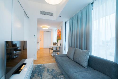 a living room with a couch and a table at Vienna Residence, Marina Tower - Danube in Vienna