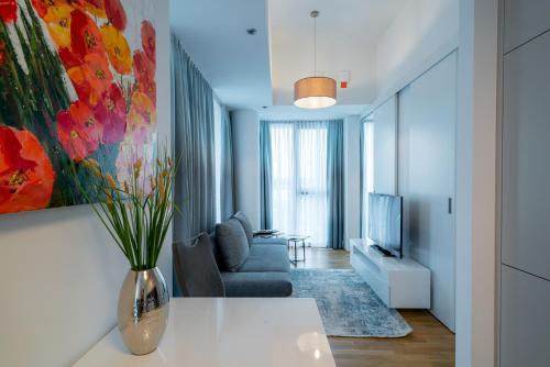 a living room with a couch and a vase at Vienna Residence, Marina Tower - Danube in Vienna