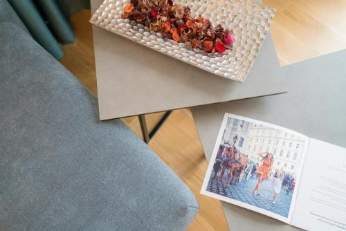 a table with a box of flowers and a book at Vienna Residence, Marina Tower - Danube in Vienna