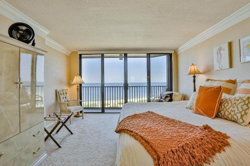 a bedroom with a bed and a view of the ocean at Lighthouse Towers 1002 in Clearwater Beach