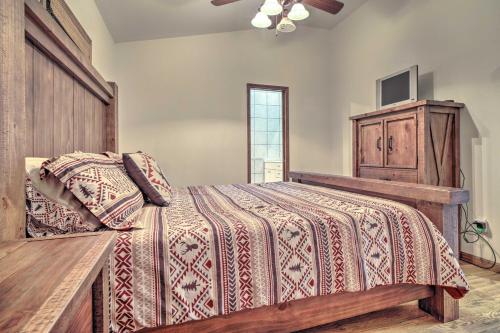 a bedroom with a bed and a tv on the wall at Home on Douglas Lake - Fish and Kayak! in Dandridge