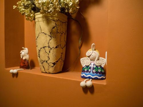 a shelf with a vase and a figurine next to a vase at Chata Cyborga in Stronie Śląskie