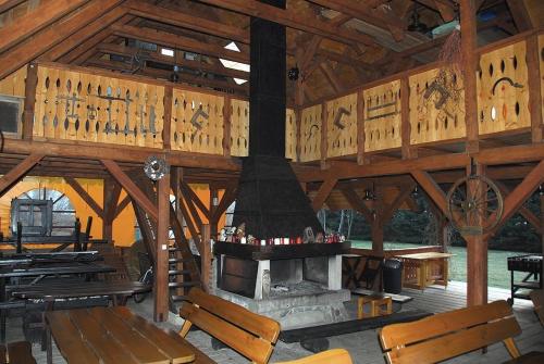 a large wooden pavilion with a fireplace in it at Chata Cyborga in Stronie Śląskie