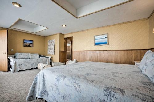 a bedroom with a large bed and two beds at Oceanside Getaway with Beach Access and Home Gym! in Coos Bay