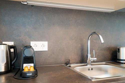 a kitchen counter with a sink next to a sink at Vienna Residence, Marina Tower - Danube in Vienna
