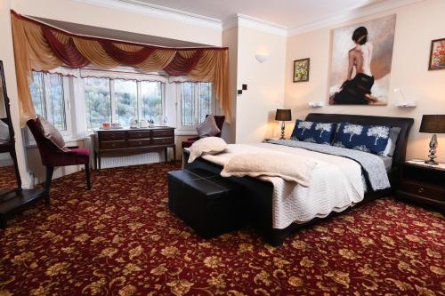 a bedroom with a bed and a desk at Luxury Suite in quiet countryside location in Swansea