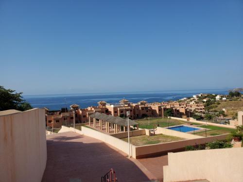 a view of a resort with the ocean in the background at Apartment C6 Phase 4 Mojon Hills, Isla Plana, CERTIFICATE OF EXCELLENCE in Isla Plana
