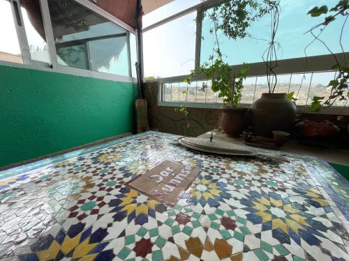 a room with a tiled floor with a window at Dar Sunrise Fes in Fès