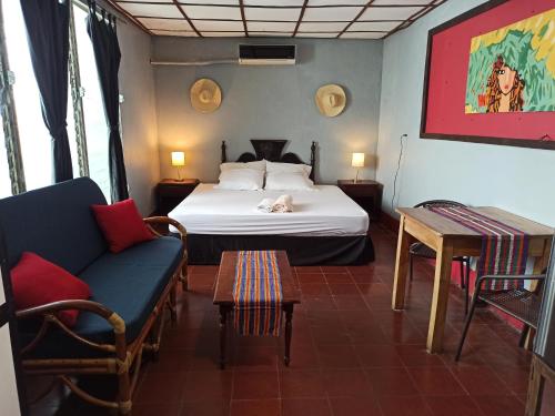 a bedroom with a bed with a cat laying on it at Harvest House in León