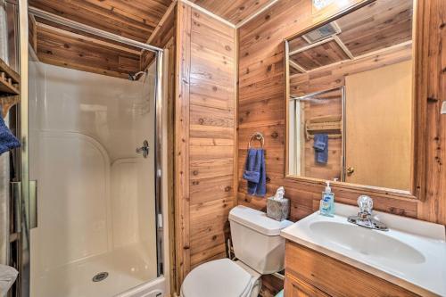 a bathroom with a toilet and a shower and a sink at Atlanta Waterfront Cabin with Dock and Kayaks! 