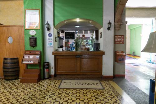 a restaurant with a counter in a room at Hotel Colonial in Aguascalientes
