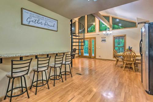 a room with a bar with chairs and a table at Lakefront Hideaway in Scranton Spacious Deck in Scranton