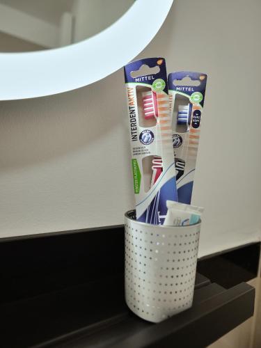 a trash can with toothbrushes and toothpaste at Apartment OTTO I - Erfurt Zentrum in Erfurt