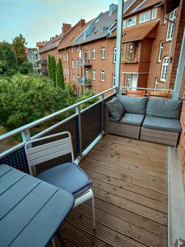 a balcony with a couch and chairs on a building at Apartment OTTO I - Erfurt Zentrum in Erfurt