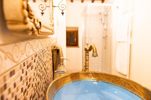 a bathroom with a gold sink and a mirror at Casa alle Monache in Gambassi Terme