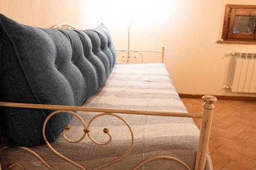 a bed with a blue blanket on top of it at Casa alle Monache in Gambassi Terme