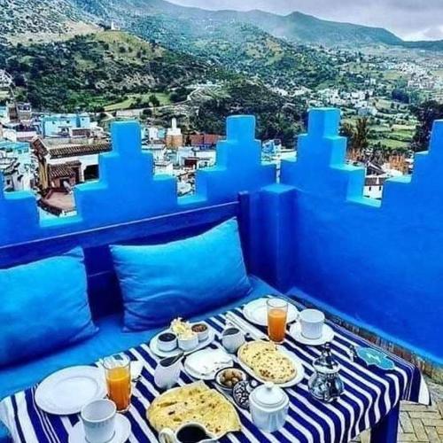 a blue room with a table with food on it at Casa Plasa Grande in Chefchaouene