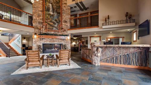 a lobby with chairs and a fireplace in a house at Best Western Plus High Country Inn in Ogden