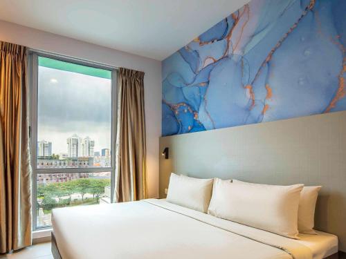 a bedroom with a bed and a large window at ibis Styles Singapore Albert in Singapore