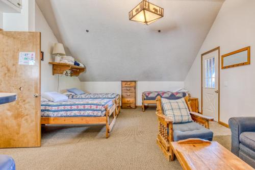 a bedroom with two beds and a couch and a table at Little Trail Lodge - Unit B in Government Camp