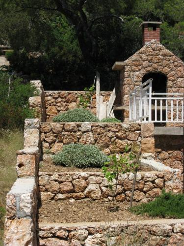 a stone wall with a bench on top of it at Apartment Sveta Nedilja 14086a in Jelsa