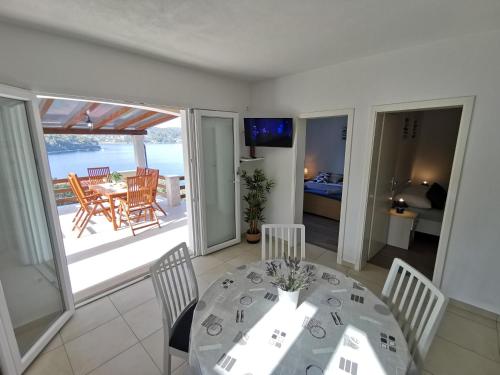 - une salle à manger avec une table et une vue sur l'océan dans l'établissement Secluded fisherman's cottage Cove Picena, Korcula - 14090, à Vela Luka